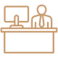 Icon of a businessman at a desk with a computer, representing professional office environments in commercial remodeling by Kaplan Remodeling.